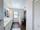 Bathroom with double sink vanity, toilet, and standing shower with glass door at 1715 S Pebble Beach Blvd, Sun City Center, FL 33573