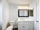 This is a bathroom with white walls, a new sink vanity, and a dark frame mirror at 1715 S Pebble Beach Blvd, Sun City Center, FL 33573