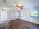 Bedroom with hardwood floors, ceiling fan, and a large closet at 1715 S Pebble Beach Blvd, Sun City Center, FL 33573