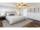 This bedroom offers a ceiling fan and wood floors, creating a welcoming ambiance at 1715 S Pebble Beach Blvd, Sun City Center, FL 33573