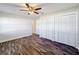 Bedroom with hardwood floors, ceiling fan, and large closet at 1715 S Pebble Beach Blvd, Sun City Center, FL 33573