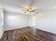 Well-lit bedroom with ceiling fan and wood-look flooring at 1715 S Pebble Beach Blvd, Sun City Center, FL 33573