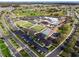 Aerial view of community with clubhouse, pool, and green spaces at 1715 S Pebble Beach Blvd, Sun City Center, FL 33573