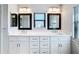 Double vanity bathroom with white cabinets and quartz countertops at 1715 S Pebble Beach Blvd, Sun City Center, FL 33573