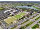 Aerial view of a community center with pool, parking and green spaces at 1715 S Pebble Beach Blvd, Sun City Center, FL 33573