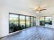 Sunroom featuring large windows and wood-look flooring at 1715 S Pebble Beach Blvd, Sun City Center, FL 33573