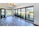 Sunroom with backyard view and wood-look flooring at 1715 S Pebble Beach Blvd, Sun City Center, FL 33573