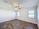 Spacious bedroom with ceiling fan and wood-look flooring at 1715 S Pebble Beach Blvd, Sun City Center, FL 33573
