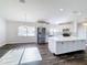 Bright kitchen and dining area with stainless steel appliances, island, and modern lighting fixtures at 1715 S Pebble Beach Blvd, Sun City Center, FL 33573