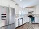 Beautiful kitchen featuring white cabinets, stainless steel appliances, and plenty of counter space at 1715 S Pebble Beach Blvd, Sun City Center, FL 33573
