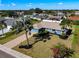 Aerial view of a single story home with a large yard and palm trees at 1715 S Pebble Beach Blvd, Sun City Center, FL 33573