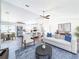 Bright, open-concept living room showcases modern decor and seamless flow to the kitchen and dining areas at 1715 S Pebble Beach Blvd, Sun City Center, FL 33573