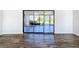 Living room with hardwood floors, sliding glass doors to the outside, and plenty of light at 1715 S Pebble Beach Blvd, Sun City Center, FL 33573