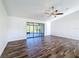 Bright living room with wood-look floors and sliding glass doors at 1715 S Pebble Beach Blvd, Sun City Center, FL 33573