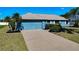 Front view of a home with a two-car garage at 1715 S Pebble Beach Blvd, Sun City Center, FL 33573