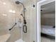 Bathroom with walk-in shower, built-in seat, and grab bar at 3401 W North B St, Tampa, FL 33609