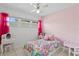 Bedroom with pink walls and white brick accent wall at 3401 W North B St, Tampa, FL 33609