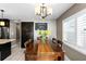 Dining area with wood table, yellow flowers, and window at 3401 W North B St, Tampa, FL 33609