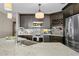 Modern kitchen with dark brown cabinets, granite countertops, and stainless steel appliances at 3401 W North B St, Tampa, FL 33609