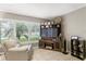 Living room with off-white chair, wood entertainment center, and large windows at 3401 W North B St, Tampa, FL 33609