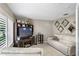 Living room with off-white couch, wood entertainment center, and large windows at 3401 W North B St, Tampa, FL 33609