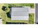 Aerial view of a single-Gathering home with a metal roof and paved driveway at 37635 Gill Ave, Zephyrhills, FL 33541