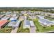 Aerial view of a single-Gathering home in a 55+ community with a metal roof and paved driveway at 37635 Gill Ave, Zephyrhills, FL 33541