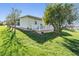 Landscaped backyard with a deck and lush greenery at 37635 Gill Ave, Zephyrhills, FL 33541