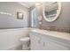 Clean bathroom with white vanity and a large, round mirror at 37635 Gill Ave, Zephyrhills, FL 33541