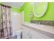 Bathroom with lime green walls, white vanity and shower/tub combo at 37635 Gill Ave, Zephyrhills, FL 33541