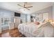 Bright bedroom featuring a large bed, dresser and wood-look floors at 37635 Gill Ave, Zephyrhills, FL 33541