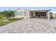 Single-story home with covered porch and paver driveway at 37635 Gill Ave, Zephyrhills, FL 33541
