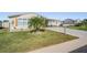 Single-wide manufactured home with covered carport and landscaped lawn at 37635 Gill Ave, Zephyrhills, FL 33541