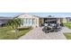 Well maintained manufactured home with paved driveway and golf cart at 37635 Gill Ave, Zephyrhills, FL 33541