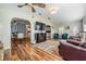 Open living room with hardwood floors, a fireplace, and ample natural light at 37635 Gill Ave, Zephyrhills, FL 33541