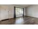 Bright living room featuring gray vinyl flooring and a large window at 7930 Aden Loop, New Port Richey, FL 34655