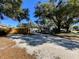 Exterior of house with gravel driveway and fence at 909 35Th N St, St Petersburg, FL 33713