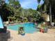 Refreshing pool with surrounding tropical plants and patio furniture at 909 35Th N St, St Petersburg, FL 33713