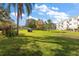 Expansive grassy lawn area with mature trees and a tranquil setting at 2457 Ecuadorian Way # 29, Clearwater, FL 33763