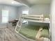 Bright bedroom with a bunk bed and wood-look floors at 1114 Palm Bluff St, Clearwater, FL 33755