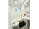 Updated bathroom with marble tile, pedestal sink, and shower/tub combo at 1114 Palm Bluff St, Clearwater, FL 33755
