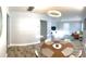 Modern dining area with a wood table and chairs, opening to living room at 1114 Palm Bluff St, Clearwater, FL 33755