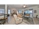 Open living room with comfortable seating, and views into the kitchen and dining area at 1120 Emerald Dunes Dr, Sun City Center, FL 33573