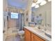 Clean bathroom with a tub shower combo and wood vanity at 1120 Emerald Dunes Dr, Sun City Center, FL 33573