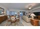 Dining room with glass-top table and view into living room at 1120 Emerald Dunes Dr, Sun City Center, FL 33573