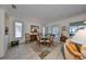 Bright dining room with glass-top table and access to the patio at 1120 Emerald Dunes Dr, Sun City Center, FL 33573