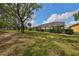 Home with a screened enclosure and lush landscaping, overlooking a paved pathway at 1120 Emerald Dunes Dr, Sun City Center, FL 33573