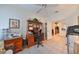 Bright home office with built-in cabinetry and view of kitchen at 1120 Emerald Dunes Dr, Sun City Center, FL 33573