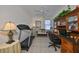 Home office with built-in desk and a treadmill at 1120 Emerald Dunes Dr, Sun City Center, FL 33573