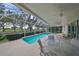 Screened-in lanai with pool and outdoor dining area at 1120 Emerald Dunes Dr, Sun City Center, FL 33573